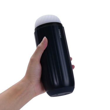 a hand holding a black and white cup